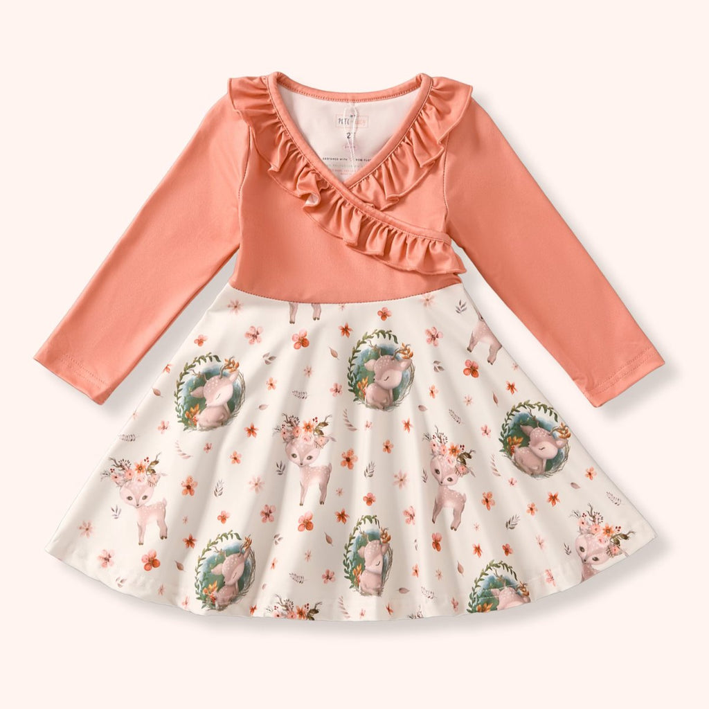 Children's dress with pink top and white skirt featuring animal prints on a white background